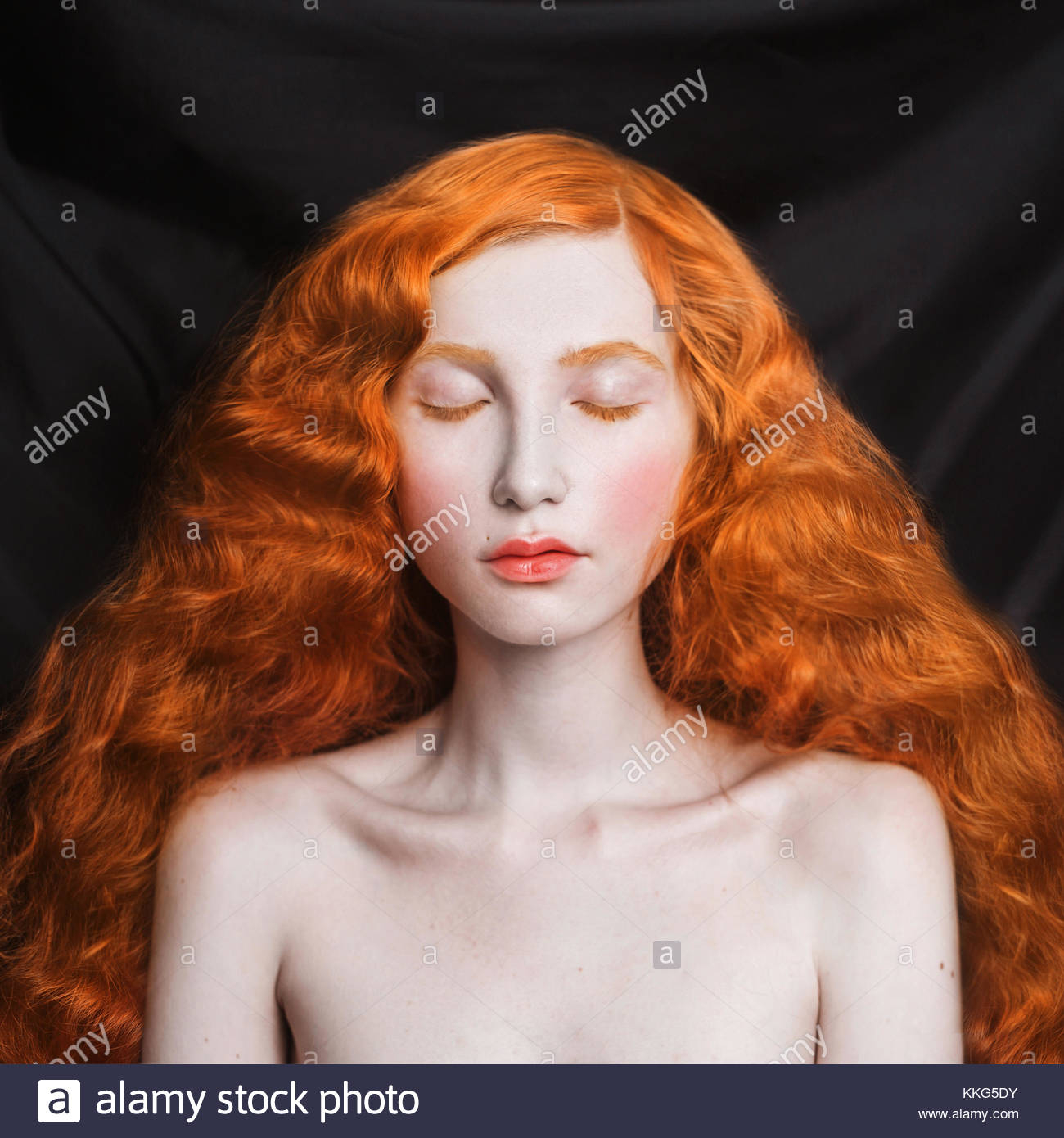 Makeup For Blue Eyes Red Hair Woman With Long Curly Red Flowing Hair On A Black Background Stock