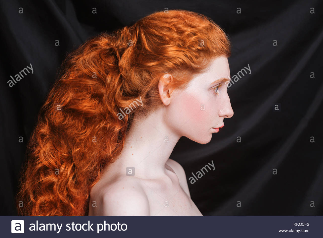 Makeup For Blue Eyes Red Hair Woman With Long Curly Red Hair Gathered In Ponytail On Black Stock