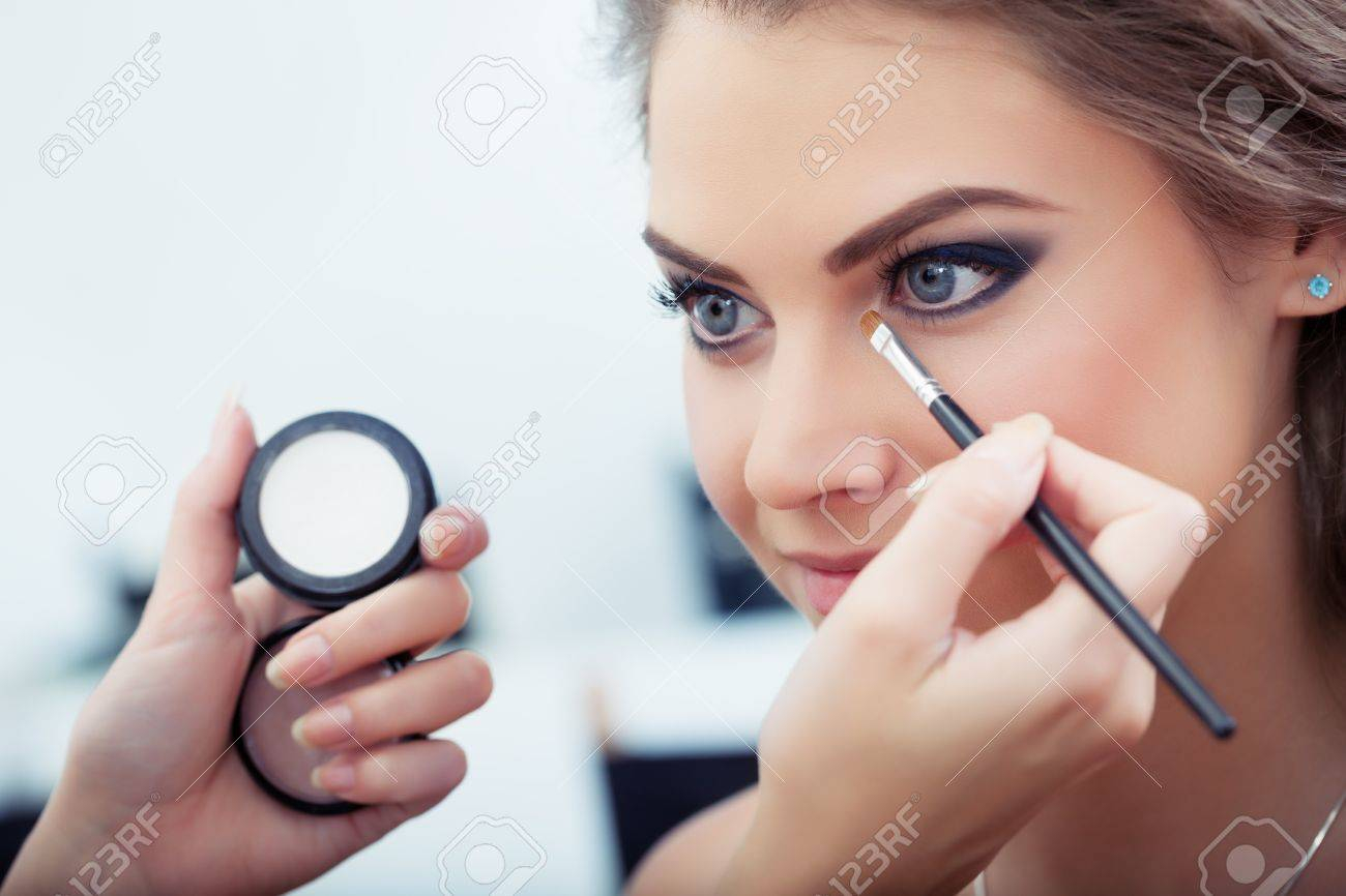 White Makeup In Corner Of Eye Make Up Artist Applying White Eyeshadow In The Corner Of Model